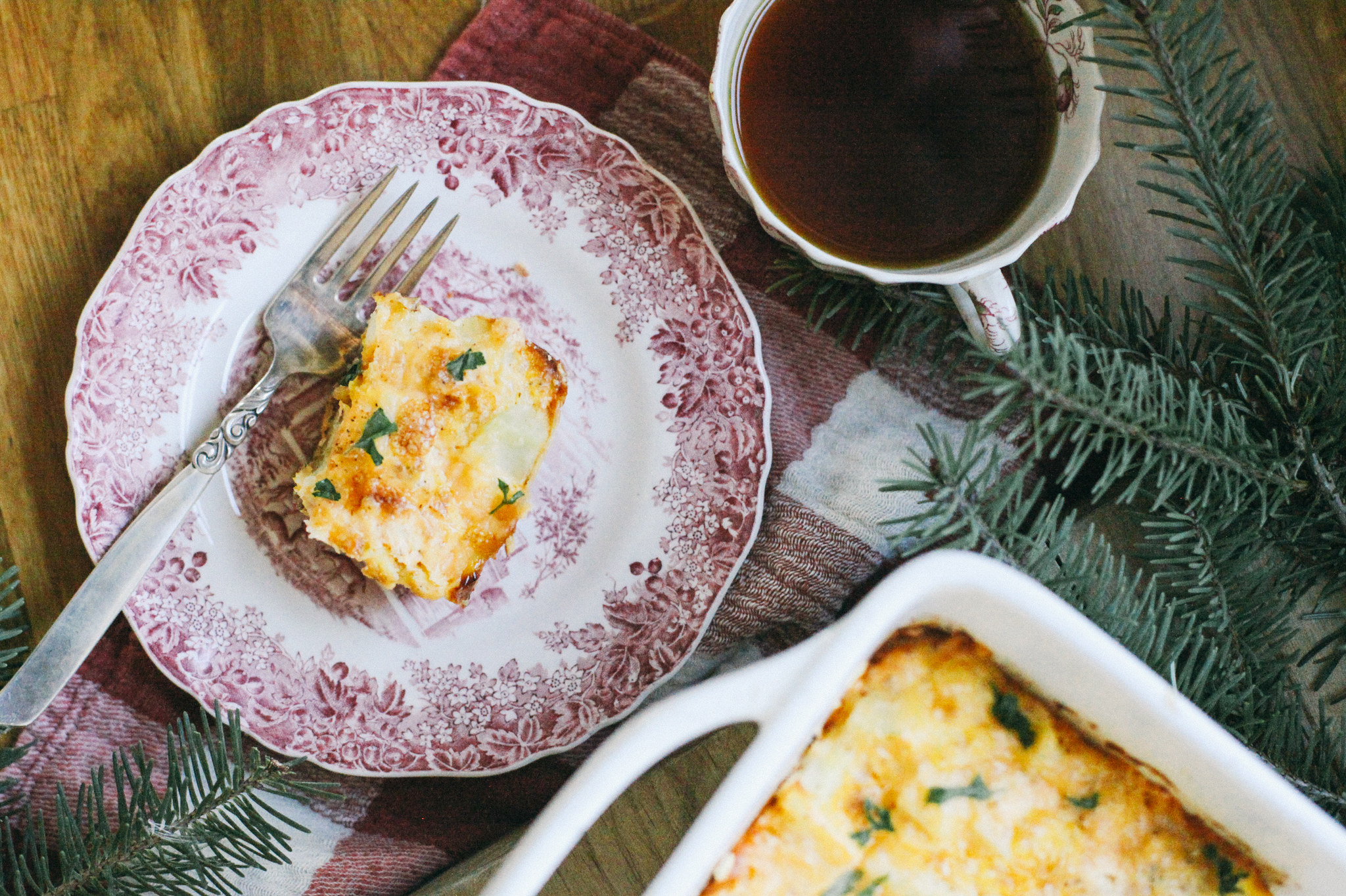 Photo of a slice of breakfast casserole with a cup of tea