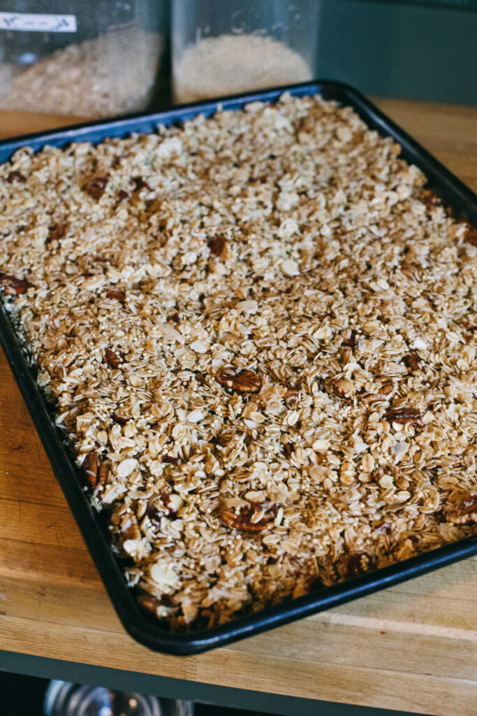 Photo of a sheet pan of raw granola ready to go in the oven to be baked