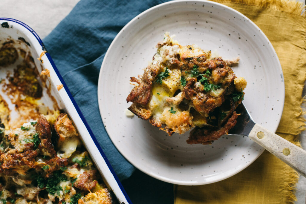 Photo of a breakfast casserole or strata with sourdough breaf and sausage
