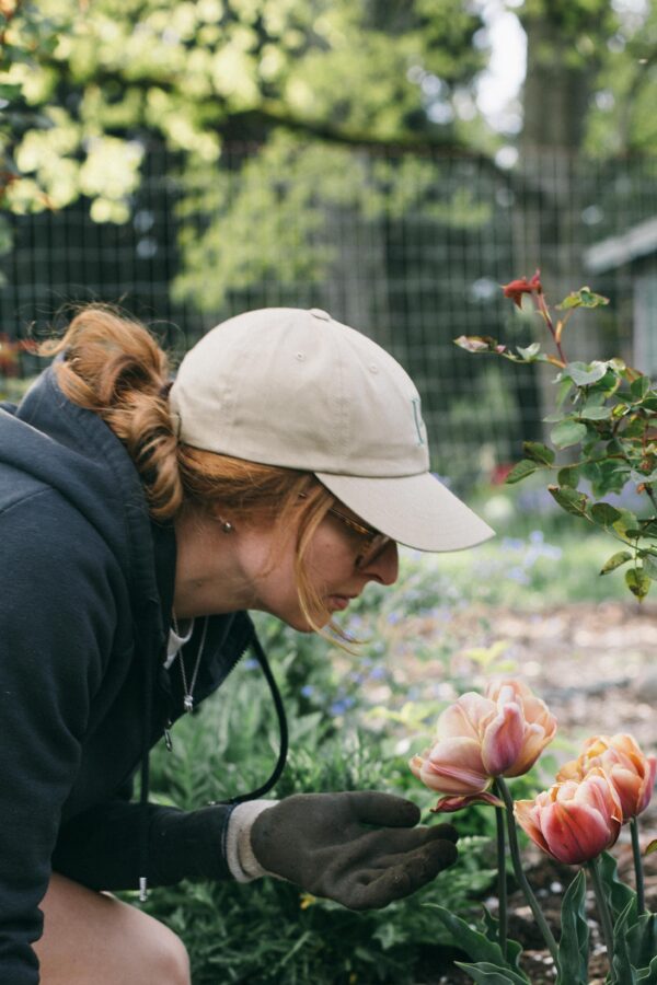 Image of a woman in a garden wearing a gardening hat from Potager Online shop