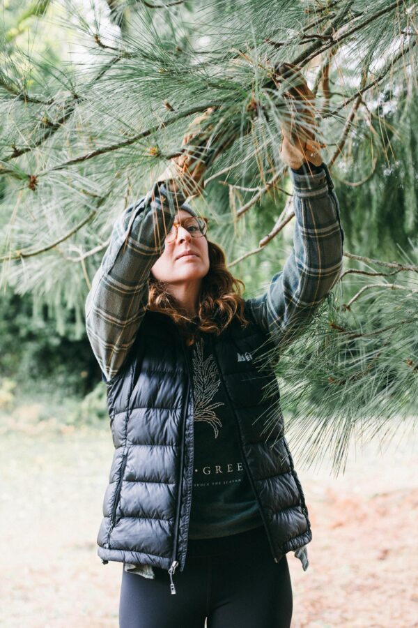 Image of a woman wearing a Potager Online Evergreen Gardening Tee
