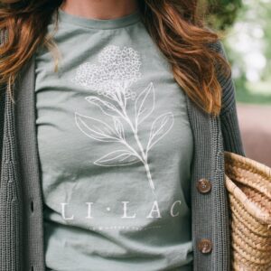 Image of a woman wearing the Lilac Gardening Tee in Sage for Potager Online