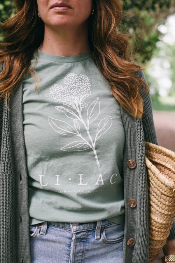 Image of a woman wearing the Lilac Gardening Tee in Sage for Potager Online