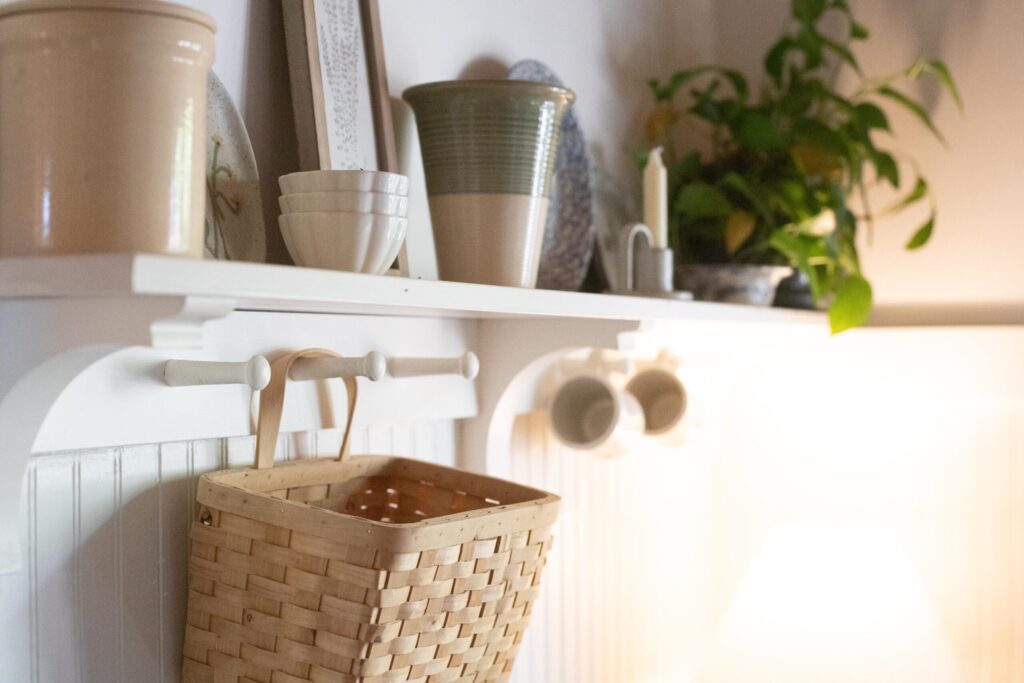 Image of a shelf filled with secondhand treasures in a Swedish Cottage Kitchen