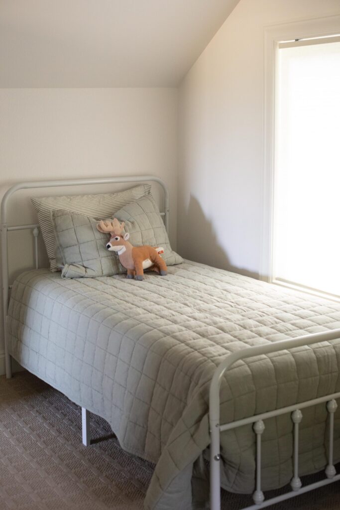 Image of a kids attic bedroom with secondhand furniture and linens