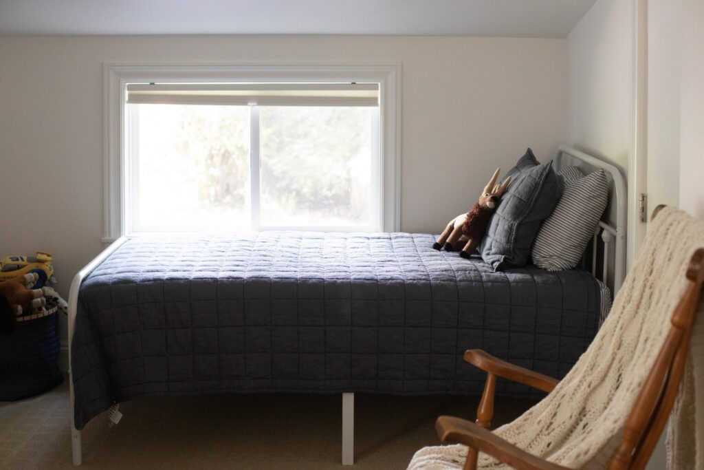 Secondhand furniture and linens in an attic kids bedroom