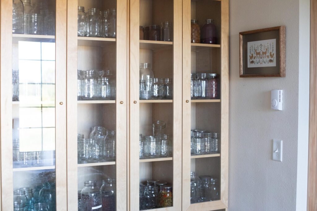 Image of a secondhand IKEA cabinet being used as canning storage