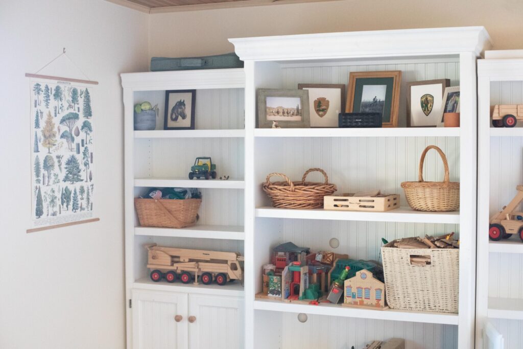 Image of secondhand wood shelves with beadboard in a cottage playroom
