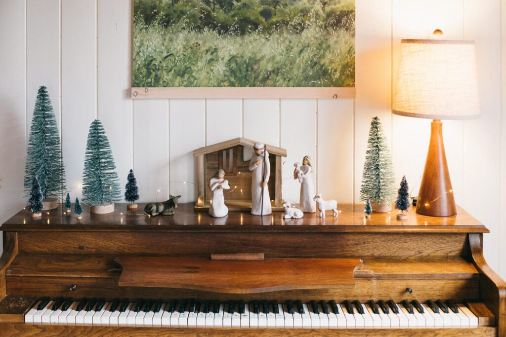 Image of a Willow Tree manger scene on top of a piano decor for a Cottage Christmas