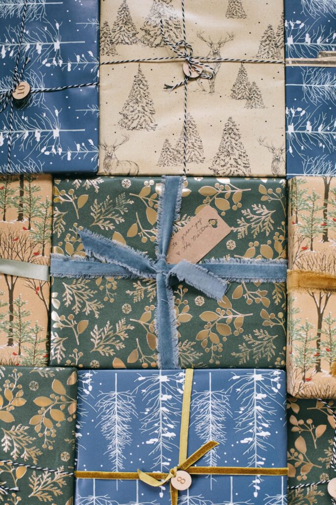 Image of Cottage Christmas wrapping paper with trees, deer, snow, floral wrapping paper, velvet ribbon