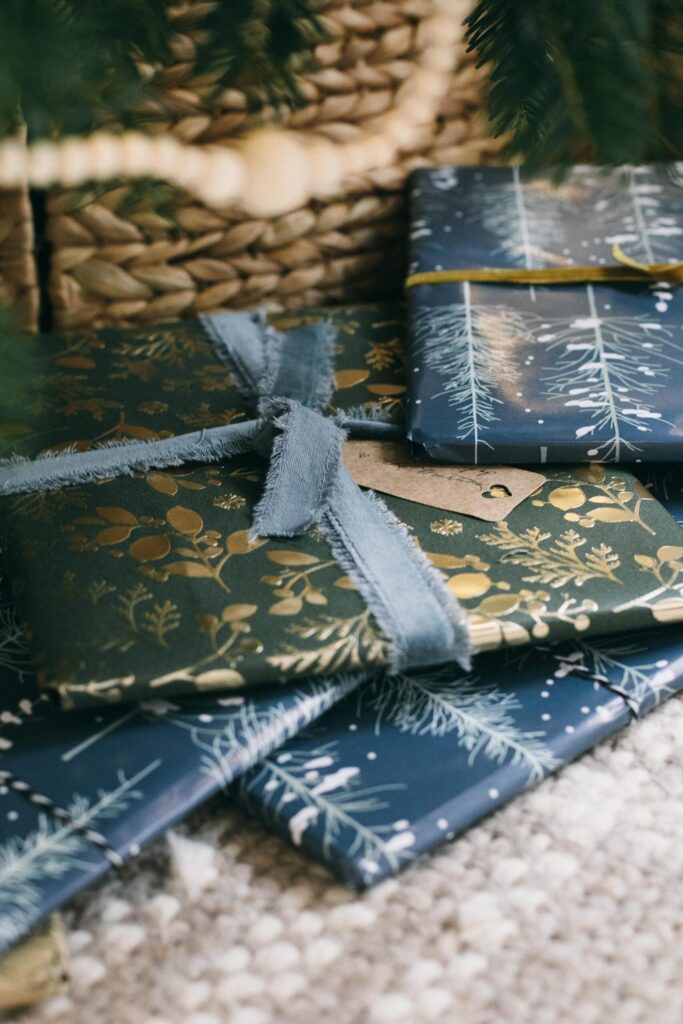 Image of presents wrapped in calming Cottage Christmas colors under the tree