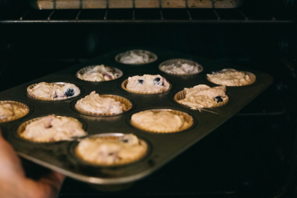 Image of a tray of Einkorn Blueberry Muffins going in the oven